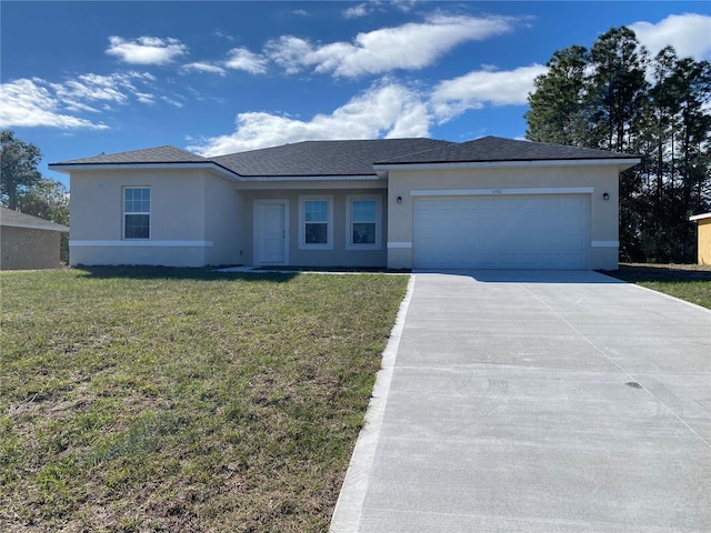 view of front of property with a garage and a front lawn