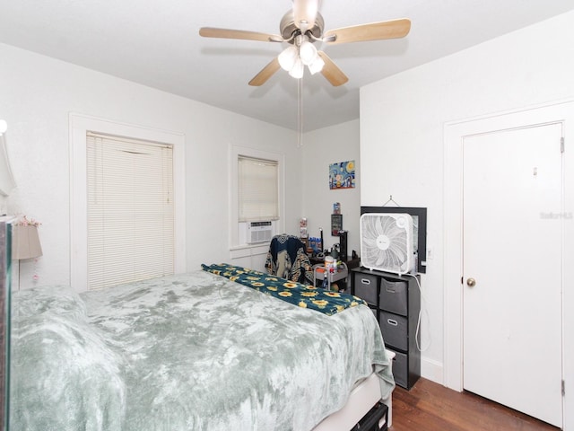 bedroom with dark hardwood / wood-style floors and ceiling fan