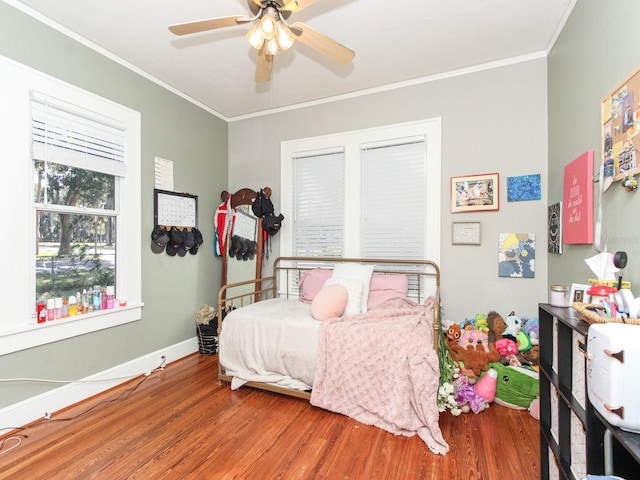 bedroom with ceiling fan, ornamental molding, and hardwood / wood-style floors