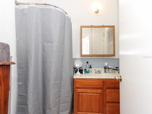 bathroom featuring vanity and a shower with shower curtain