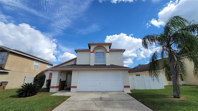 view of front of home with a front lawn and a garage