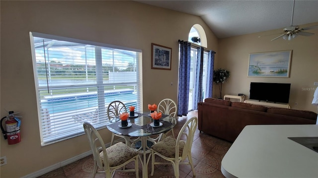 dining area featuring vaulted ceiling and ceiling fan