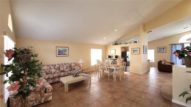 living room with lofted ceiling and a healthy amount of sunlight