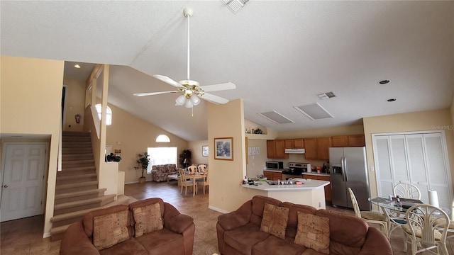 living room with ceiling fan and high vaulted ceiling