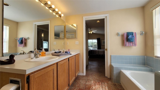 bathroom with vanity, a healthy amount of sunlight, and a bathtub