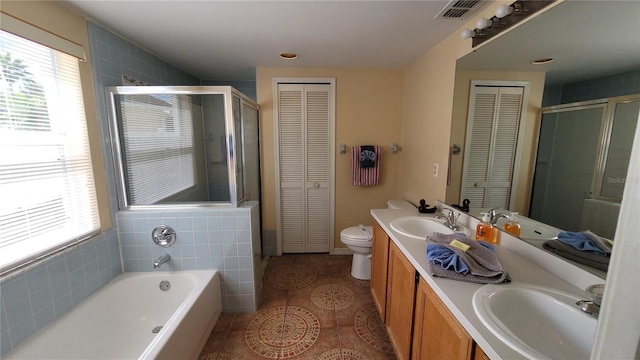 full bathroom with vanity, plus walk in shower, tile patterned floors, tile walls, and toilet