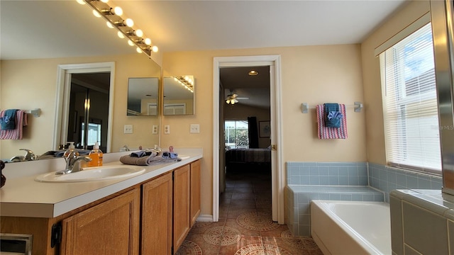 bathroom with vanity, a washtub, tile patterned floors, and a wealth of natural light