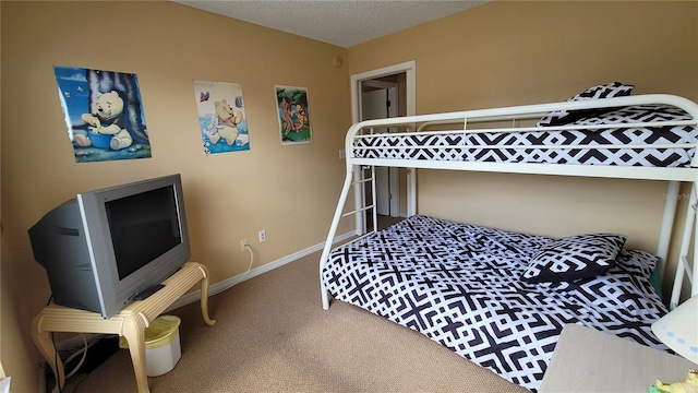 bedroom featuring a textured ceiling and carpet