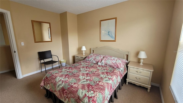 bedroom with carpet floors and a textured ceiling