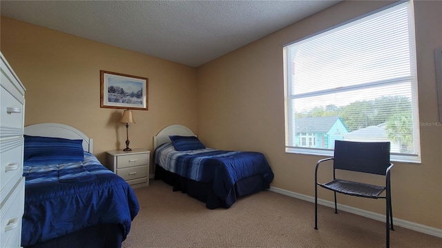 bedroom featuring light carpet and a textured ceiling