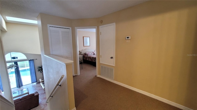 hallway with carpet floors