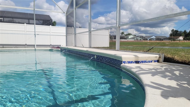 view of swimming pool featuring a lanai and pool water feature