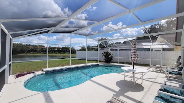 view of swimming pool featuring glass enclosure, a water view, a yard, and a patio