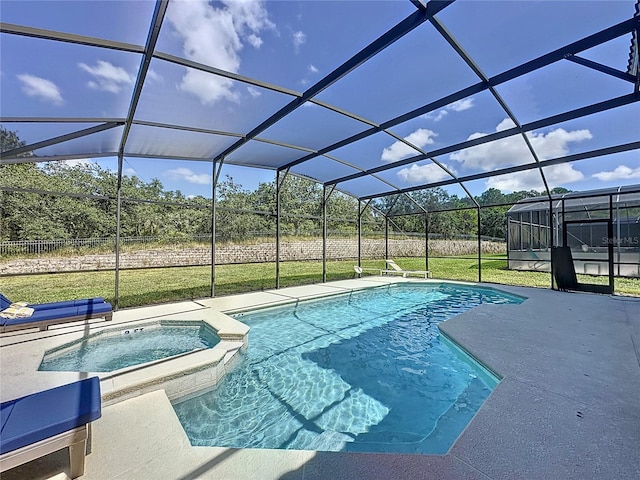 view of pool featuring an in ground hot tub, a yard, glass enclosure, and a patio area