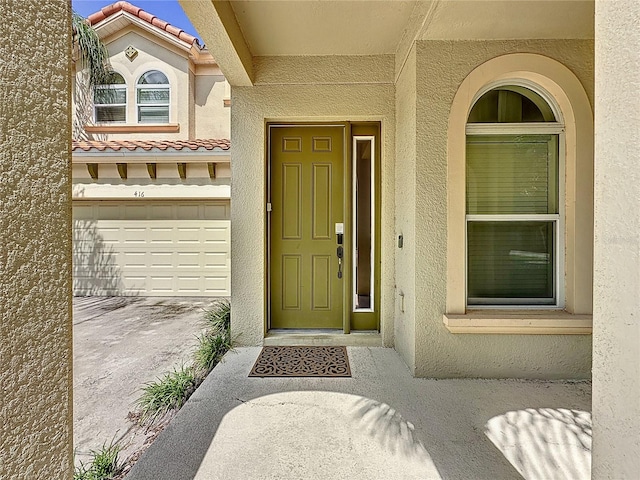 416 Orange Cosmos Blvd, Davenport, FL 33837 - doorway to property featuring a tile roof, stucco siding, and an attached garage