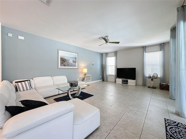 416 Orange Cosmos Blvd, Davenport, FL 33837 - living room with ceiling fan, light tile patterned floors, and baseboards