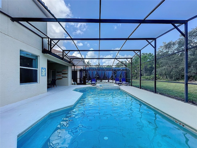 view of pool featuring a patio, an in ground hot tub, and glass enclosure