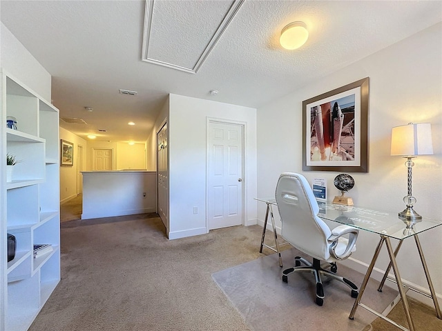 home office featuring carpet floors and a textured ceiling