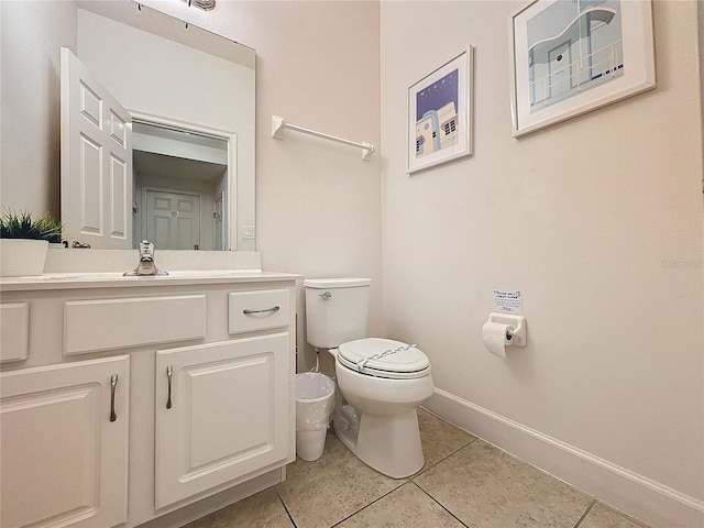 bathroom featuring tile patterned floors, vanity, and toilet