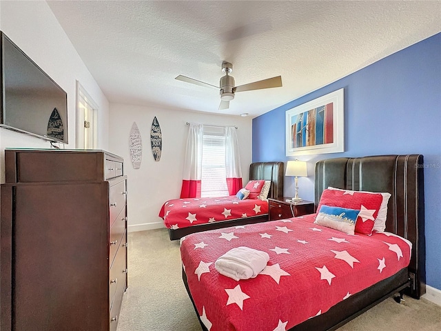 carpeted bedroom with a textured ceiling and ceiling fan