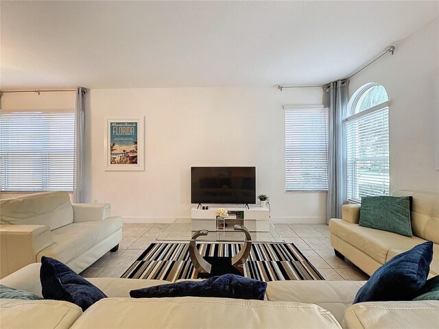 416 Orange Cosmos Blvd, Davenport, FL 33837 - tiled living room with baseboards