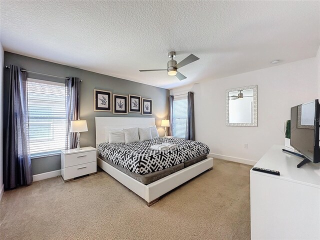 416 Orange Cosmos Blvd, Davenport, FL 33837 - bedroom featuring light carpet, baseboards, ceiling fan, and a textured ceiling