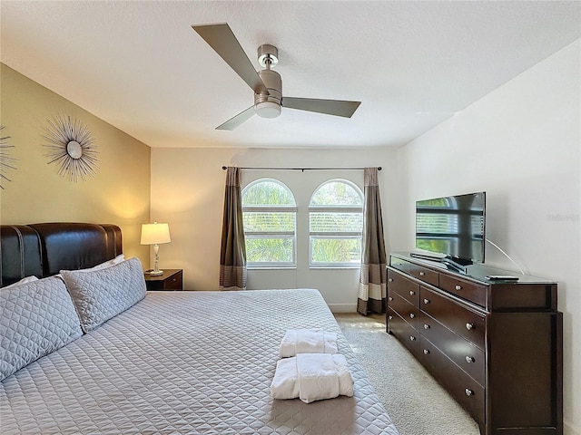 bedroom with light carpet and ceiling fan