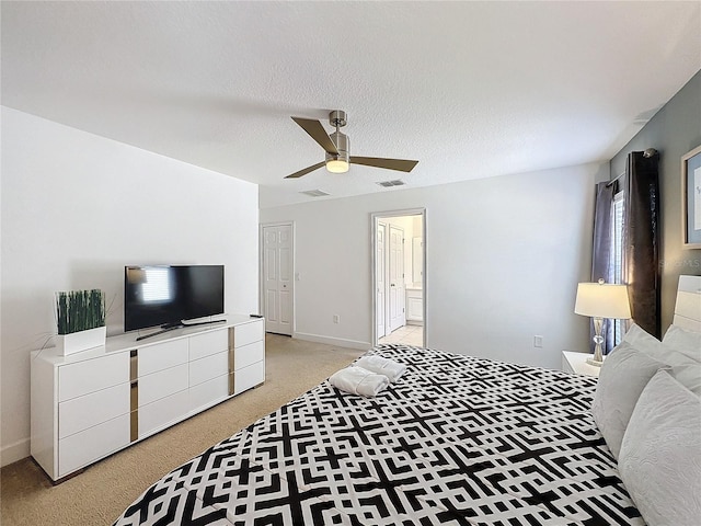 bedroom featuring ceiling fan, a textured ceiling, and connected bathroom