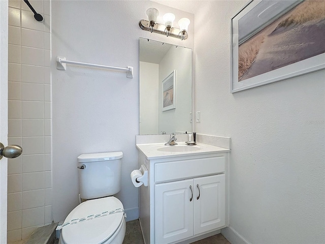 bathroom with toilet, vanity, and a shower