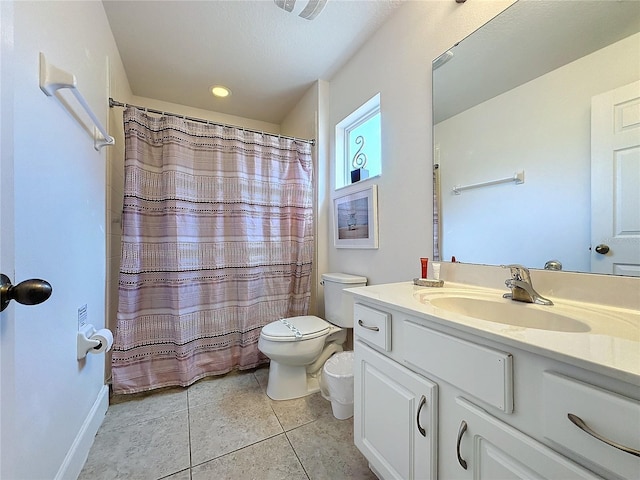 bathroom featuring curtained shower, vanity, toilet, and tile patterned floors