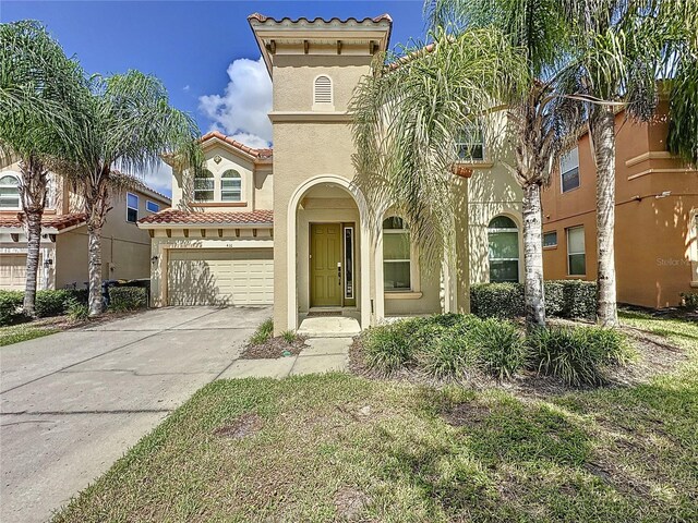 416 Orange Cosmos Blvd, Davenport, FL 33837 - view of front of house with stucco siding, an attached garage, a tiled roof, and concrete driveway