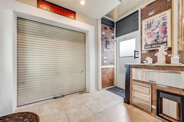 kitchen featuring a warming drawer and light tile patterned flooring