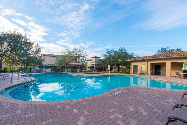 view of pool with a gazebo, a patio area, and a community hot tub