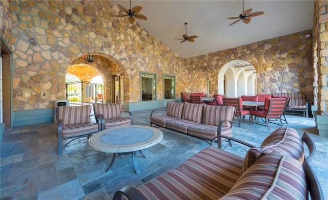 living room featuring high vaulted ceiling and ceiling fan