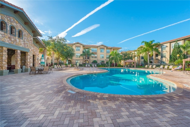 view of swimming pool featuring a patio area