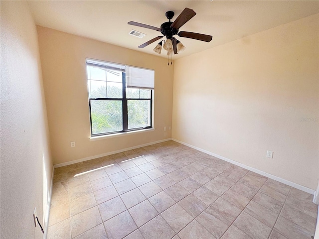 unfurnished room featuring ceiling fan and light tile patterned floors