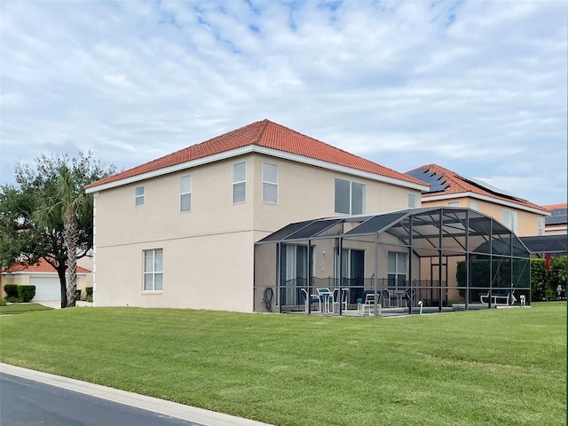 back of property featuring a lawn, a lanai, and a patio