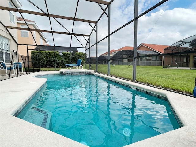 view of swimming pool with a patio, an in ground hot tub, a lanai, and a lawn