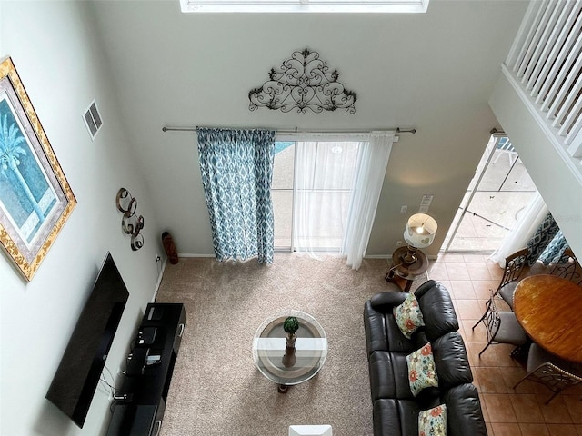 tiled living room featuring a high ceiling