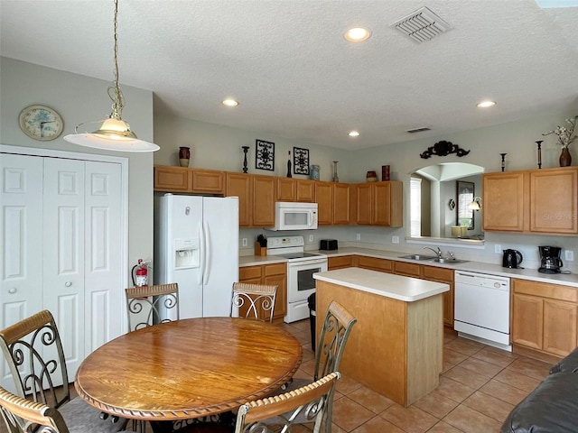 kitchen with white appliances, a kitchen island, pendant lighting, a textured ceiling, and sink