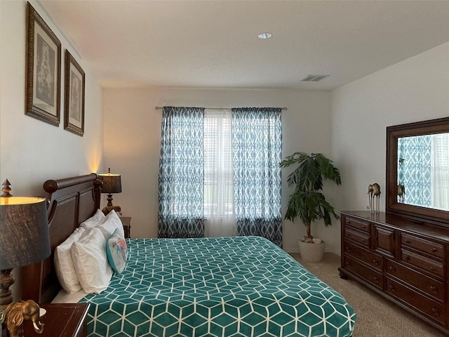 carpeted bedroom featuring multiple windows