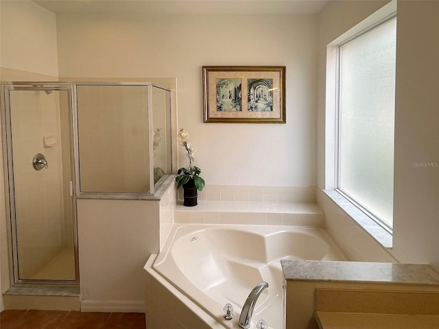 bathroom with separate shower and tub, plenty of natural light, and tile patterned flooring