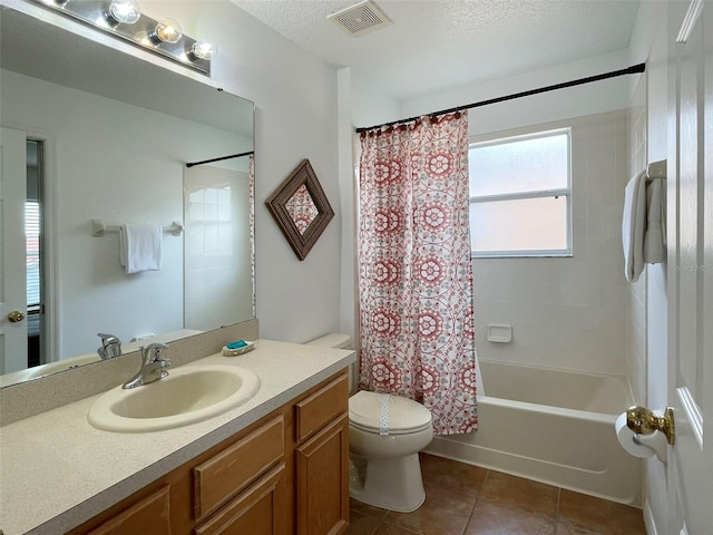 full bathroom featuring shower / bath combo with shower curtain, vanity, a textured ceiling, tile patterned flooring, and toilet