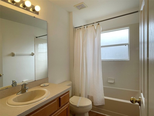 full bathroom with shower / bath combo, vanity, and toilet