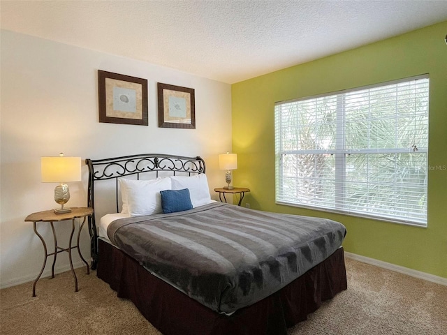 carpeted bedroom with a textured ceiling