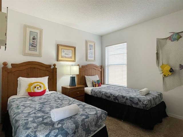 bedroom with carpet floors and a textured ceiling