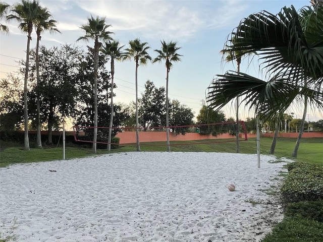 view of community featuring volleyball court and a yard