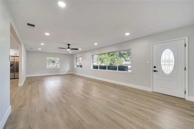 entryway with light hardwood / wood-style floors and ceiling fan