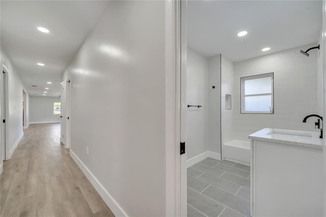 hall with sink and light hardwood / wood-style floors