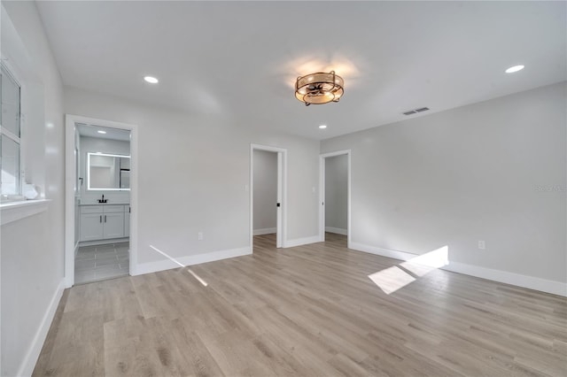 empty room with light hardwood / wood-style flooring